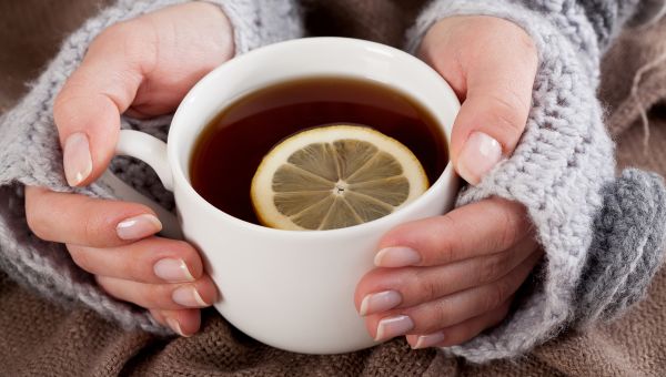 woman holding cup of tea