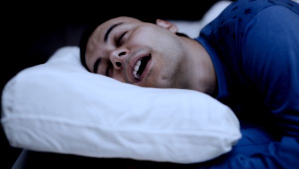 man snoring in bed