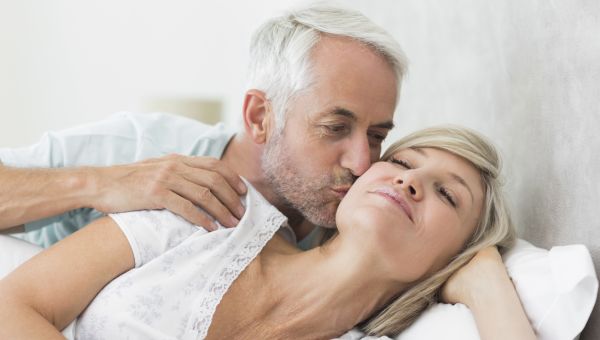 two mature people in bed
