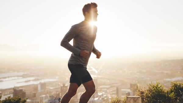 young man jogging at sunset