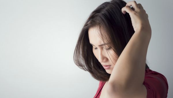 woman scratching hair
