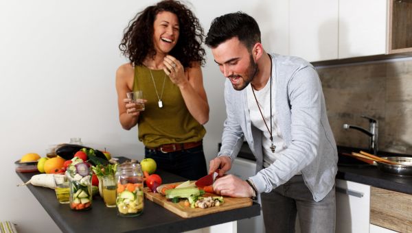 couple cooking, chopping vegetables