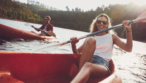 friends canoeing on river