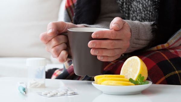 hands holding mug, mug, tea, lemons, medicine