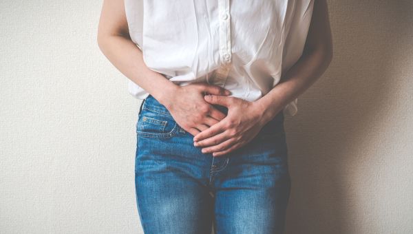 woman holding her bladder, uti, how to avoid uti, frequent urination