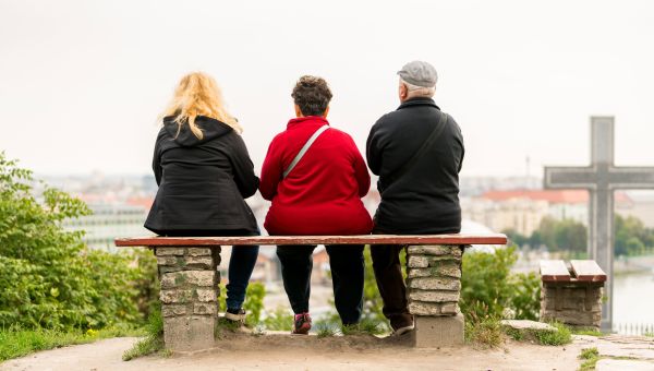 three people sitting on a bench