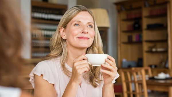 woman sipping hot tea, woman holding mug