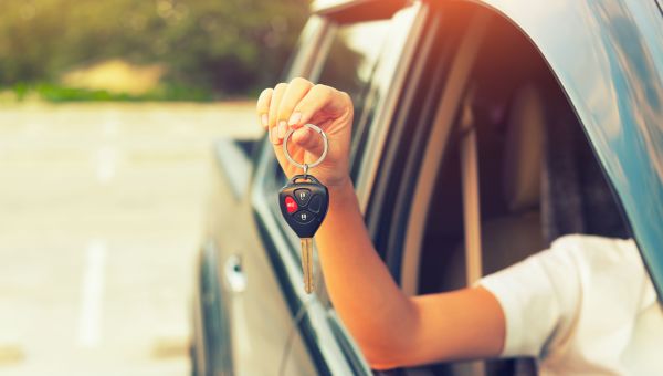 young woman holding car keys, driving hazards, driving with children