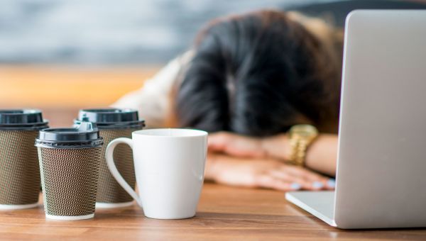 coffee cups, laptop, woman, head on desk, sleeping
