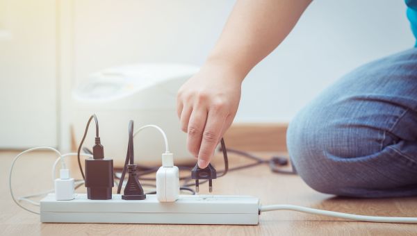 Young child touching electrical outlets