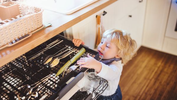 Toddler reaching into kitchen drawer