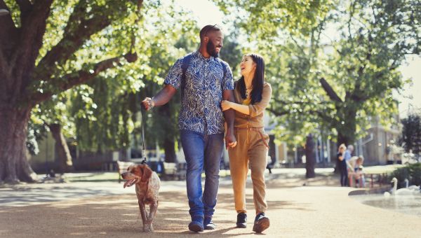 Couple walking their dog