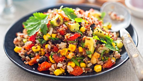 Mexican salad with corn, tomatoes and whole grains