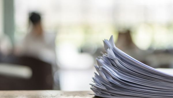 Stack of stapled papers sitting on a desk