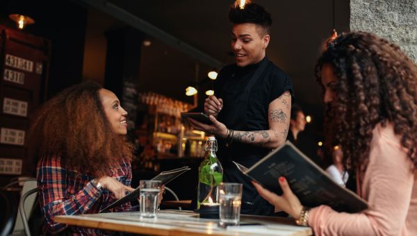 Woman ordering from waiter at a restaurant