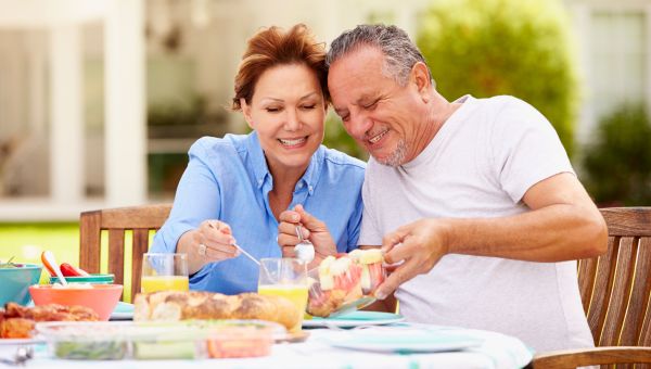 two people eating food, dining outside