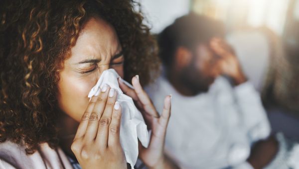 Young woman blowing her nose