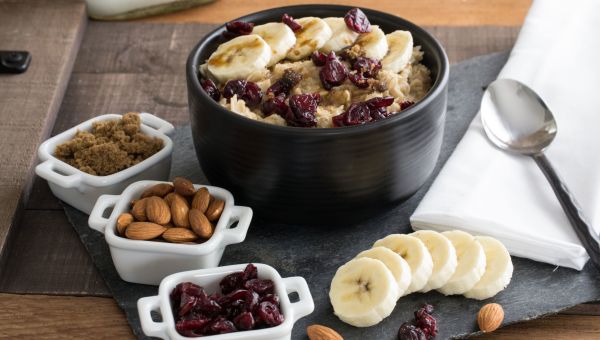 Oatmeal with banana slices, nuts and dried fruit toppings