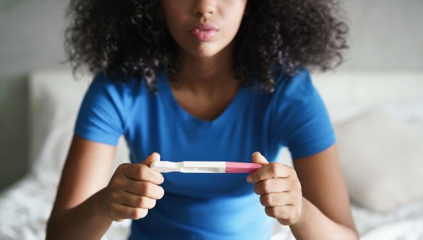 Woman holding a pregnancy test