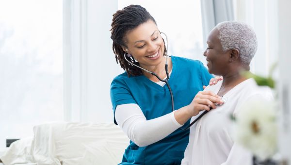 Nurse examining patient's lungs