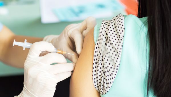 Healthcare provider holding vaccination needle