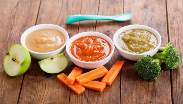 Baby food and freshly cut fruit and vegetables