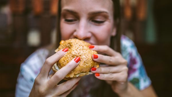 Woman eating a cheeseburger