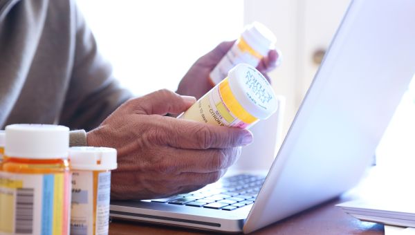 elderly man with pill bottles