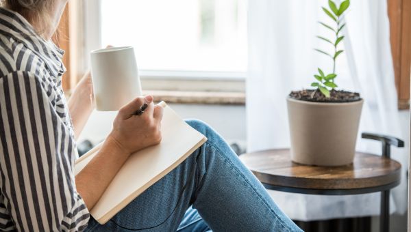 young woman writing in a notebook