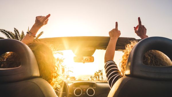 two women driving to the beach