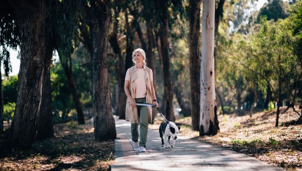 Senior woman walking her dog