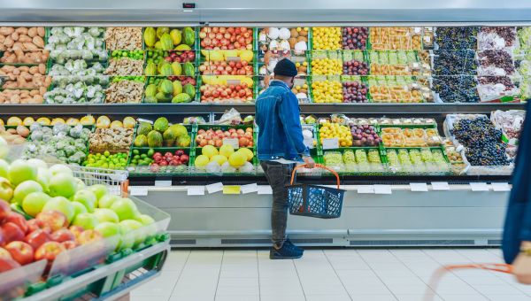 Man in produce aisle of grocery store