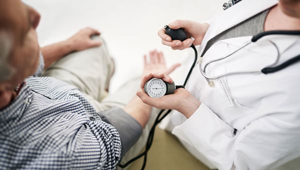 male patient getting blood pressure measured