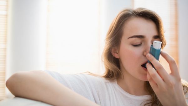 Young person using an inhaler