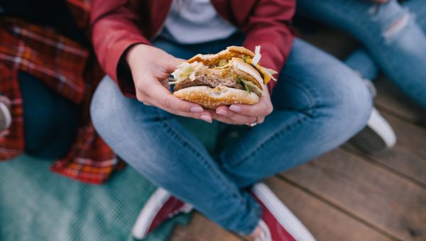 man eating a cheeseburger