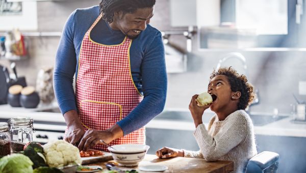 Father and child cooking healthy meal