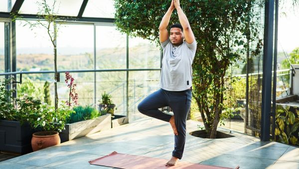 man doing tree pose