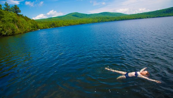 Woman floating in a beautiful lake.