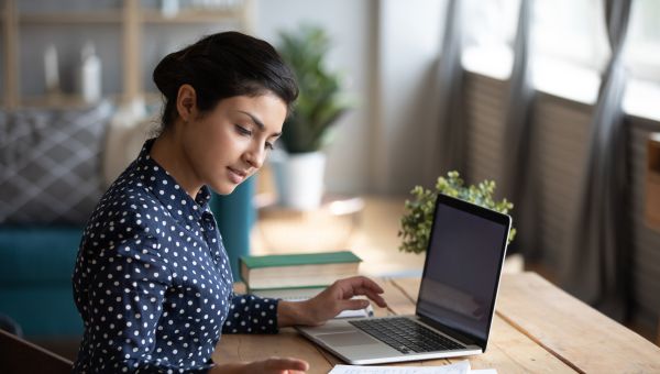 young woman at laptop looking satisfied