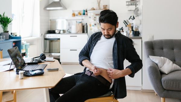 Asian man at home office with diabetes injecting insulin