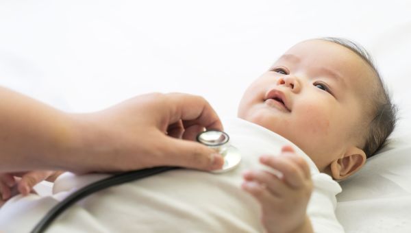 Doctor examining baby with a stethoscope