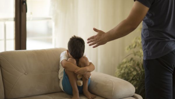 little boy being scolded by father