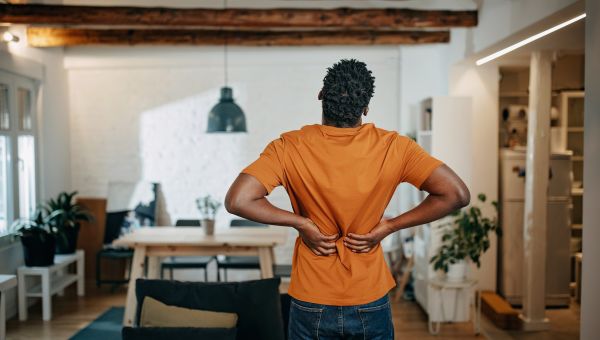 young man with lower back pain possibly indicating kidney stones