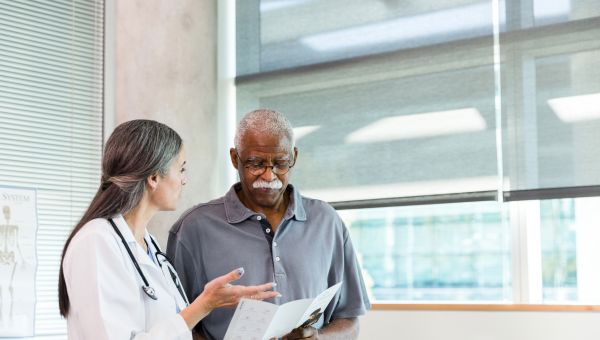 mature male patient talks to doctor