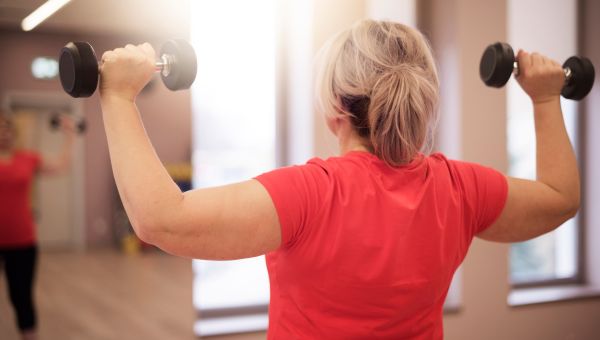 Woman works out with weights.