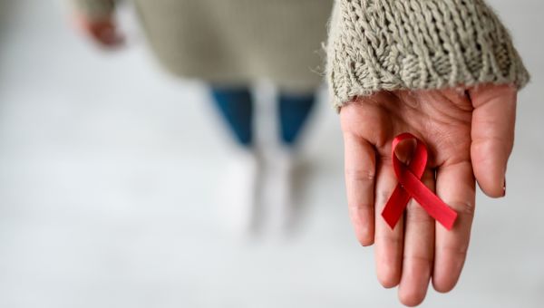 hand with AIDS ribbon