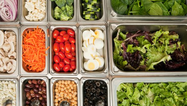 an overhead view of a salad bar with a variety of healthy vegetable and protein options