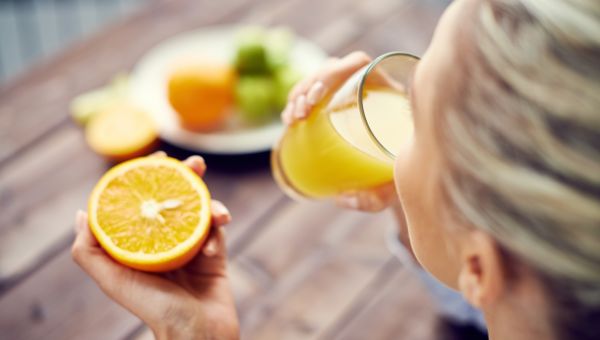 woman drinking orange juice