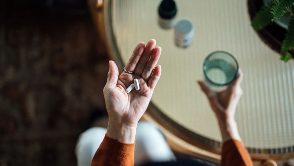 closeup of hands holding pills