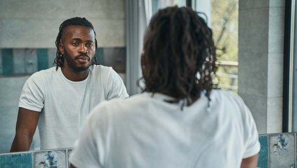 man looking in the mirror reflecting